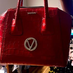 I’m selling my red alligator print bag